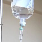 Why does IV saline drips (salt water) rehydrate us, but drinking salt water is harmful?