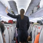 Why Do Flight Attendants Sit on Their Hands During Takeoff?
