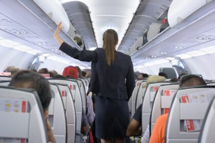 Why Do Flight Attendants Sit on Their Hands During Takeoff?